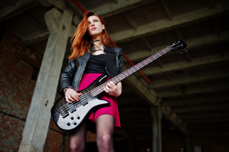 80830939-red-haired-punk-girl-wear-on-black-and-red-skirt-with-bass-guitar-at-abadoned-place-portrait-of-goth.jpg