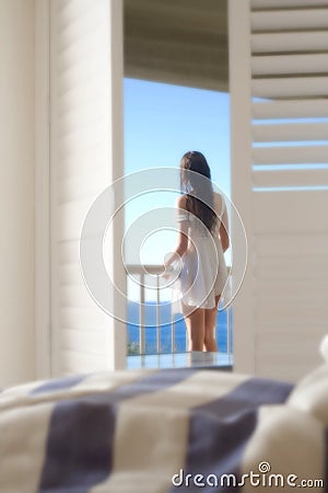 girl-on-balcony-looking-at-sea-thumb6316793.jpg