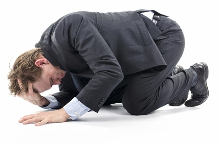 20704183-depressed-businessman-on-knees-on-the-floor-face-down.jpg