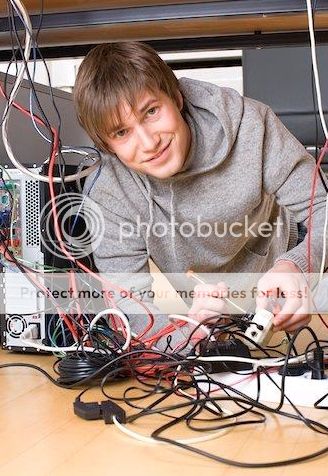 young_man_fixing_computer_in_office_820-02247752_zpsfb421a6d.jpg