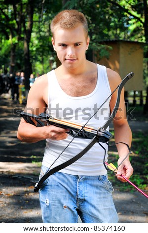 stock-photo-a-young-man-with-a-crossbow-and-arrows-in-the-woods-85374160.jpg