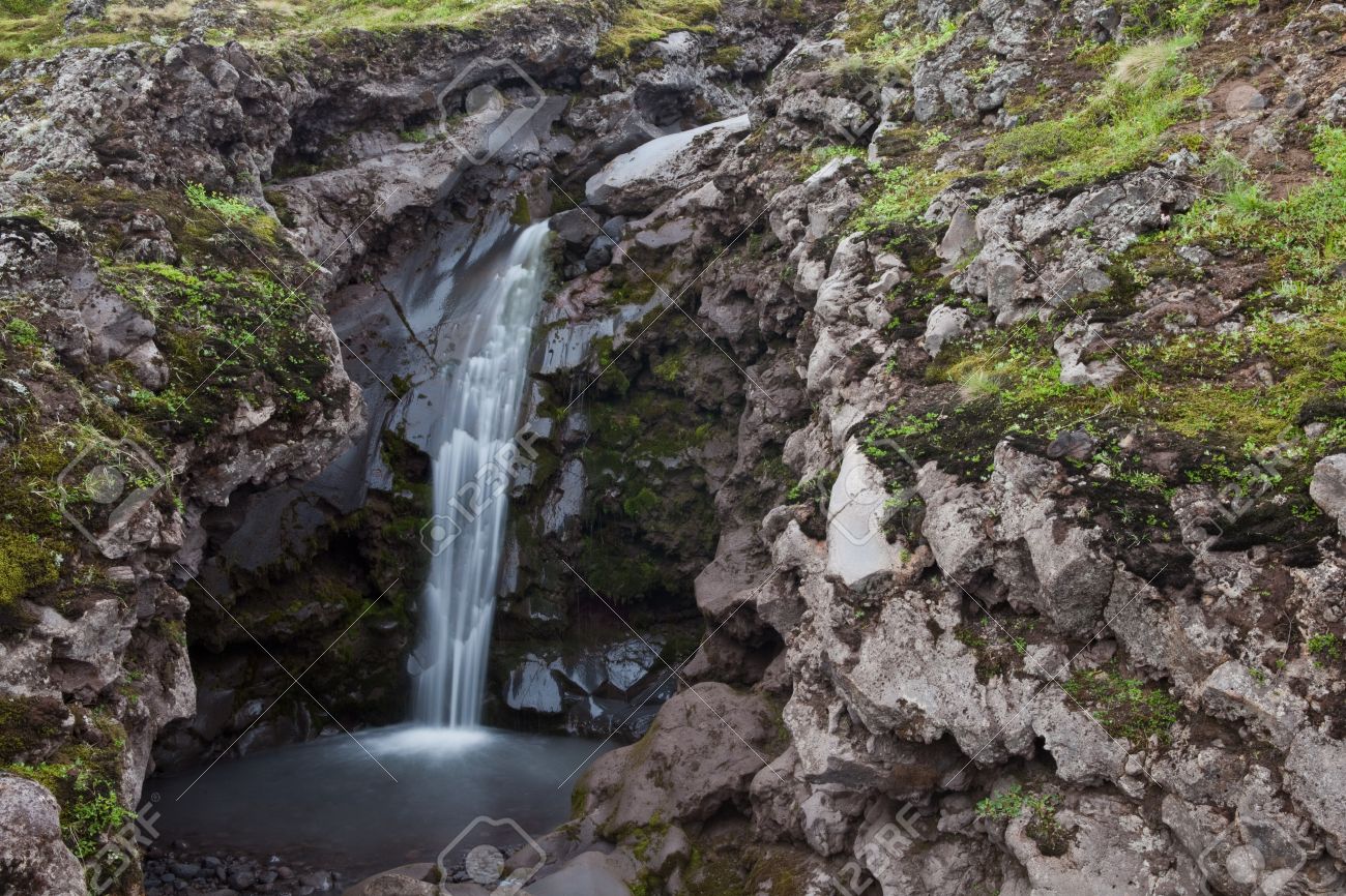 15529745-An-hidden-small-waterfall-on-the-mountain-on-Iceland-Stock-Photo.jpg
