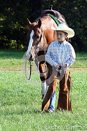 young-cowboy-walking-horse-6740357.jpg