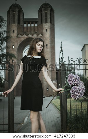 stock-photo-a-cute-goth-girl-wearing-black-dress-stands-amongst-autumnal-trees-beautiful-witch-in-the-woods-sad-417247333.jpg